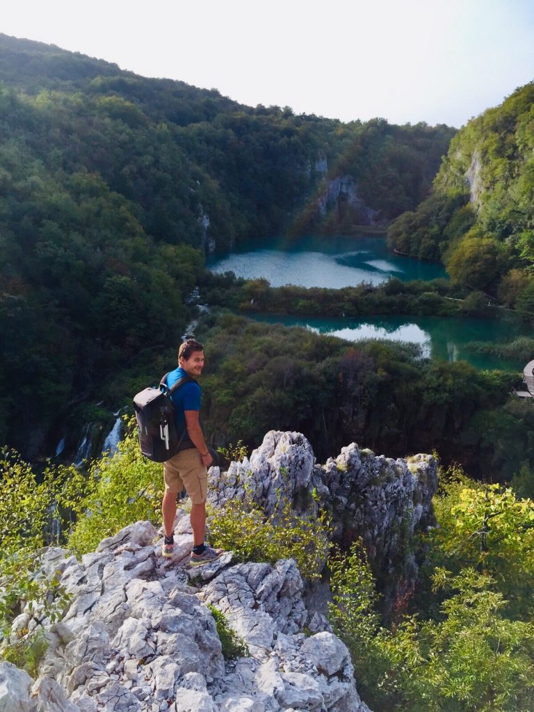 Gerben van der Waals with travelbag on a rock, Croatia.